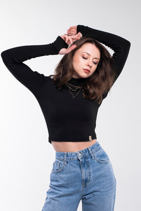 Black sweater with a high collar and long sleeves. It is light and pleasant to the touch.